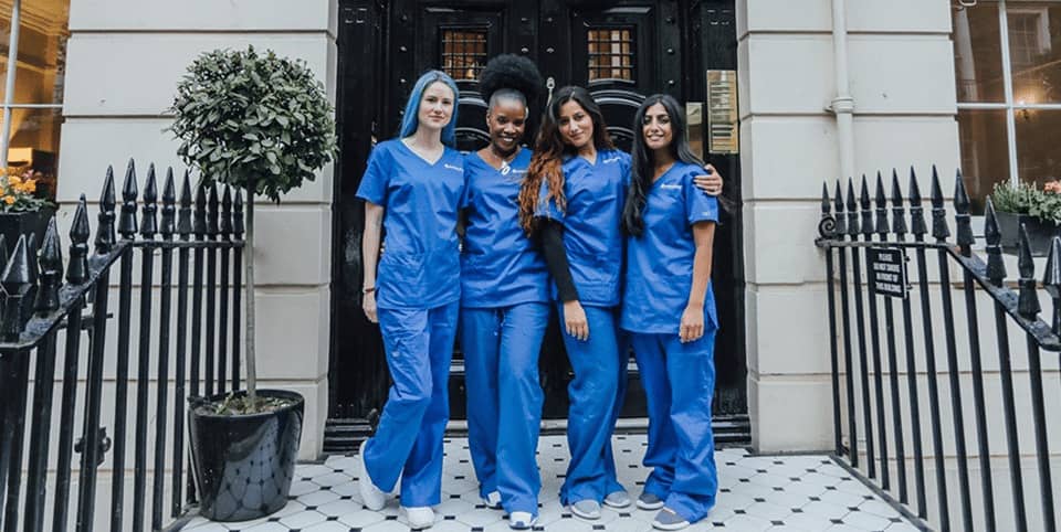 Morpheus8 skin remodelling Dublin - four nurses in blue scrubs outside a Georgian clinic Four nurses in blue scrubs outside a Georgian clinic entrance for Morpheus8 skin remodelling in Dublin
