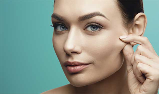 Morpheus8 skin remodelling Dublin - woman pinching the skin on her cheek Woman pinching the skin on her cheek for Morpheus8 skin remodelling in Dublin